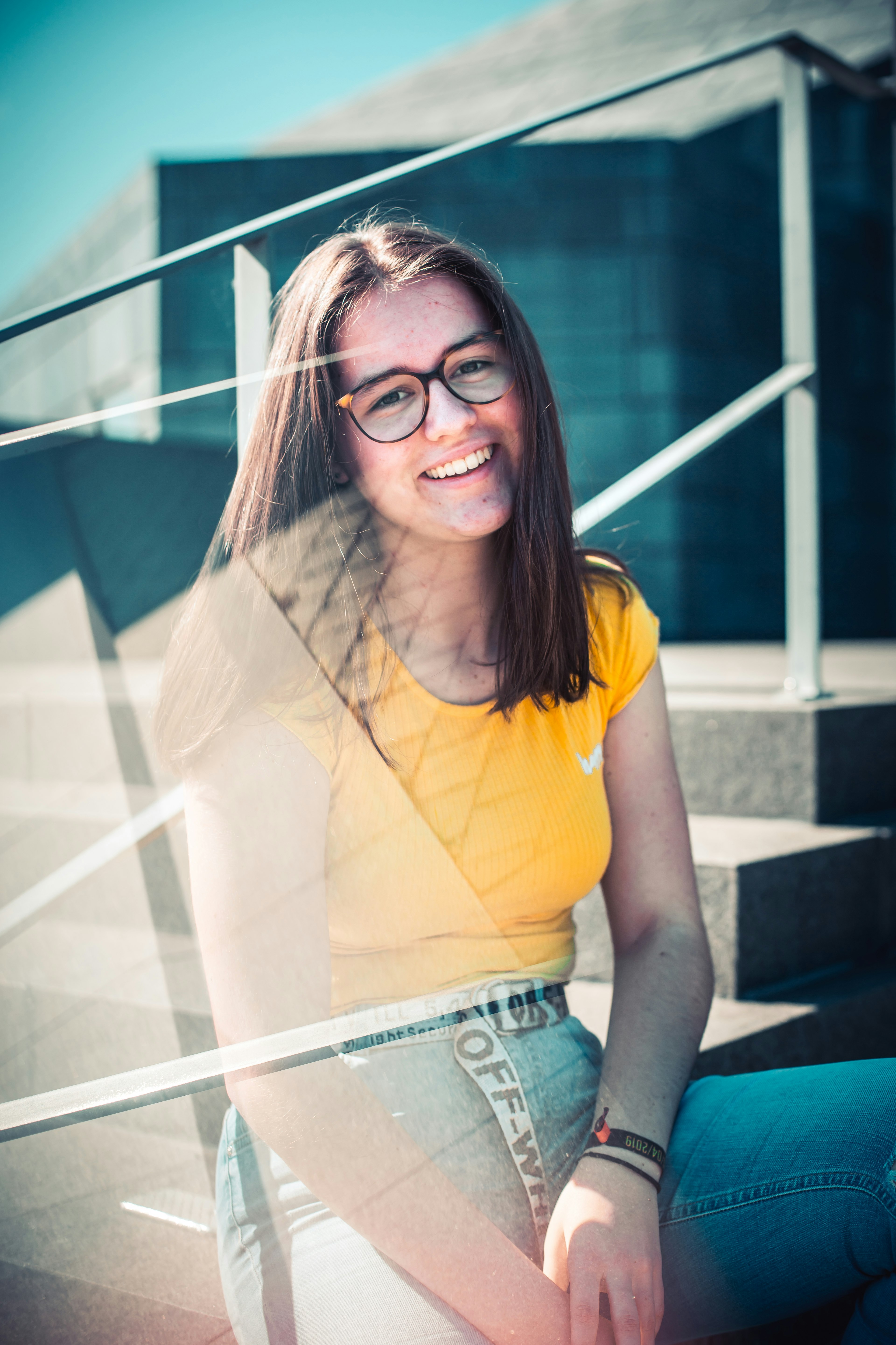 woman in yellow shirt sitting on stairs